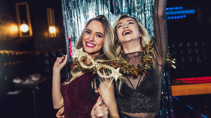 Girls celebrating new years eve at the nightclub. Group of female friends partying in pub