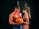 Halloween sensual couple. models each other with Pumpkin in halloween bunny mask. Design for banner. Boyfriend and girlfriend gently touch, fashion men and woman, boy girl young lovers