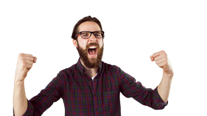 Handsome hipster cheering on white background