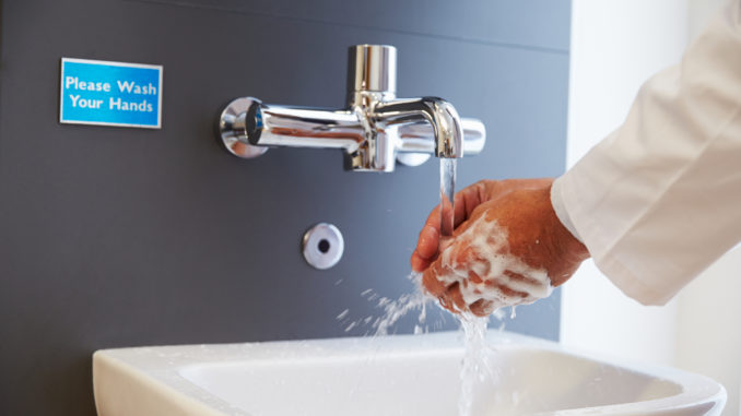 Close Up Of Medical Staff Washing Hands