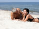 Attractive mature couple relaxing on the beach