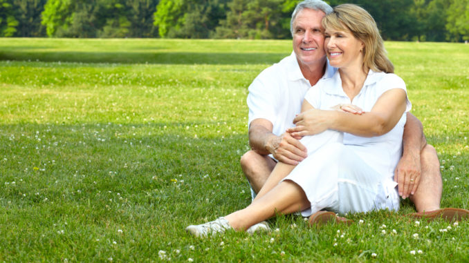 Happy elderly seniors couple in park