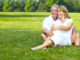 Happy elderly seniors couple in park