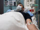 Young man lying in hospital bed.