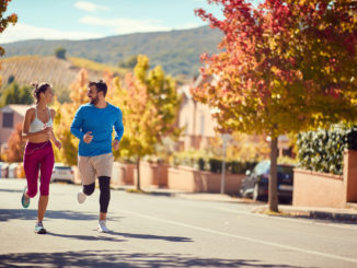 Smiling couple enjoying at jogging at city