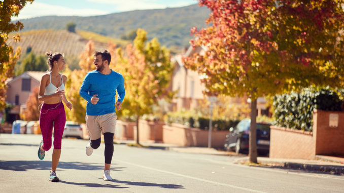 Smiling couple enjoying at jogging at city