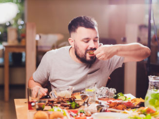 Man at the big table with food