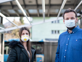 Couple on street with mask against virus pollution