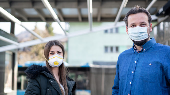 Couple on street with mask against virus pollution