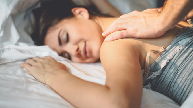 Happy couple having tender moments in the bed - Young romantic lovers intimate massaging and cuddling in the bedroom - People love relationship and relax wellness treatment concept