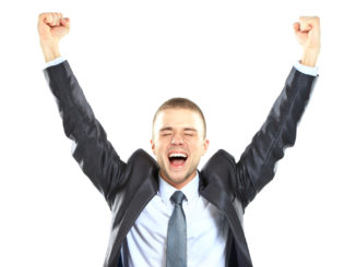 Excited handsome business man with arms raised in success - Isolated on white
