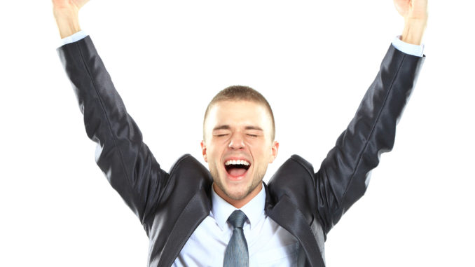Excited handsome business man with arms raised in success - Isolated on white