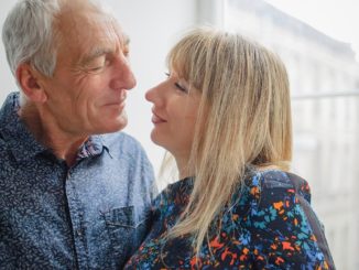 Attractive Blond Woman Hugging Handsome Senior Man