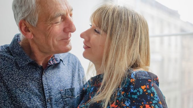 Attractive Blond Woman Hugging Handsome Senior Man