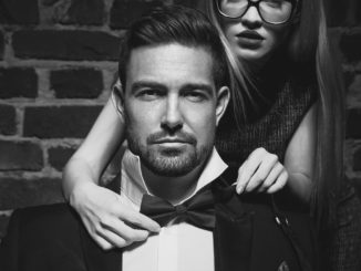 Woman tie bow for man in tuxedo black and white