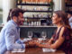 Couple On Valentines Day First Date Sitting At Table In Restaurant