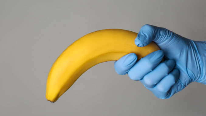 Doctor holding banana