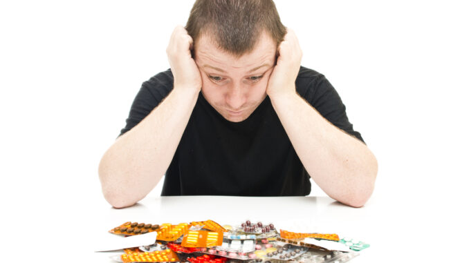 Man and medicines on a white background