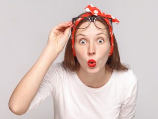 Are you serious? portrait of wondered surprised young woman in white t-shirt with freckles