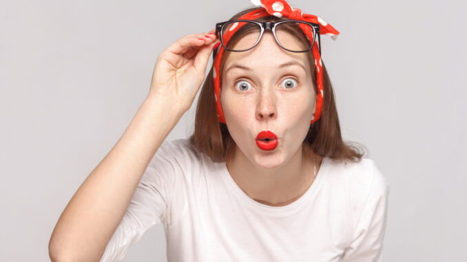 Are you serious? portrait of wondered surprised young woman in white t-shirt with freckles