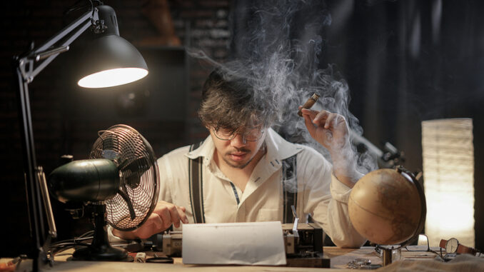 Stressed Man Smoking Cigar to Find Inspiration