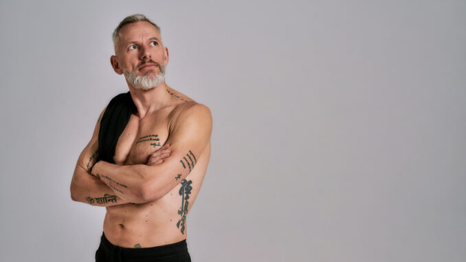 dreamstime_s_189624744 Middle aged muscular man took off black t shirt