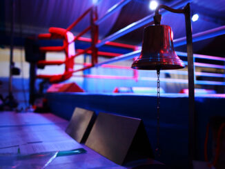 Empty boxing ring and bell