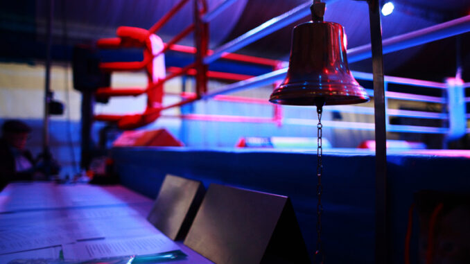 Empty boxing ring and bell