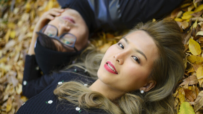 Romantic japanese couple in the autumn park.