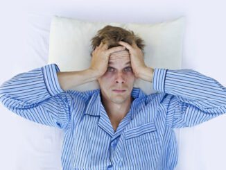 Stressed man waking up scared/worried or not able to get to sleep