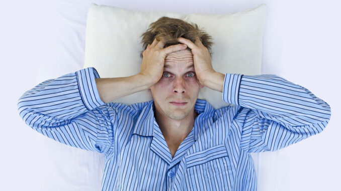 Stressed man waking up scared/worried or not able to get to sleep