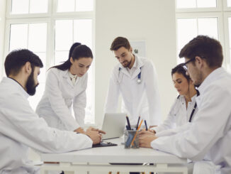 Group of doctors talking sitting at a table in the office of the hospital.