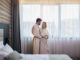 Young happy couple in hotel room in the morning.