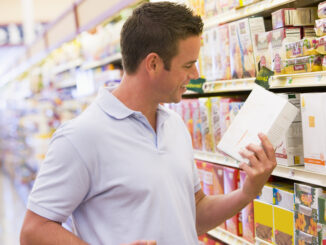 Young man grocery shopping in supermarket