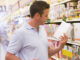 Young man grocery shopping in supermarket