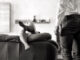 londe women in stockings seducing men on sofa in living room black and white