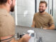 Bearded Male Person Brushing Teeth Using Electric Toothbrush