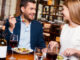 Beautiful young loving couple enjoying dinner at the restaurant