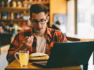 Man is eating in a restaurant and enjoying delicious food