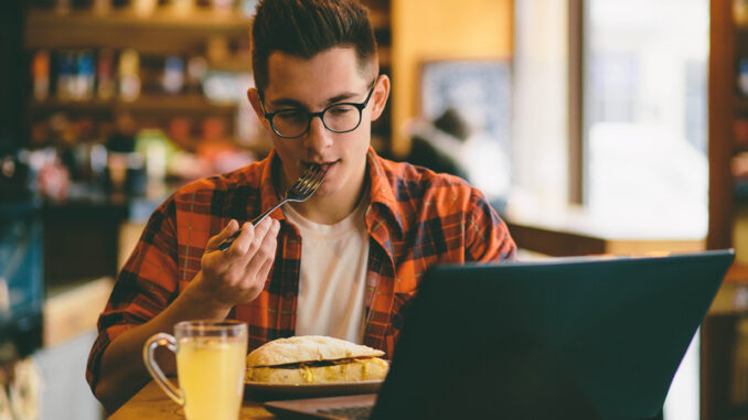 Man is eating in a restaurant and enjoying delicious food