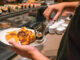 Man hand choosing sushi, lobster in the luxury buffet