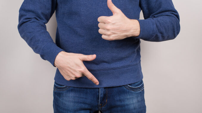 dreamstime_s_148886507 Cropped close-up photo of satisfied confident cool guy demonstrating pointing on his he organ in pants trousers isolated grey background.