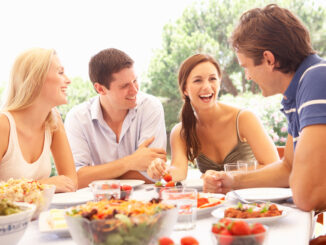 Two young couples eating outdoors Smiling