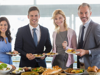 business colleagues serving themselves at buffet lunch in a restaurant