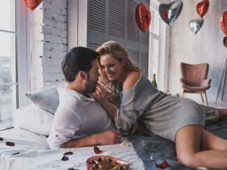 eautiful young couple eating chocolate candies