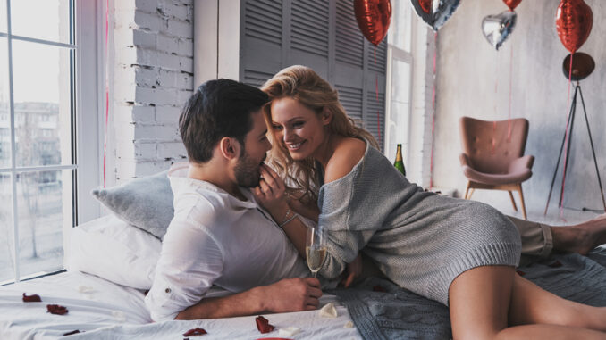 eautiful young couple eating chocolate candies