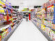 Elderly man grocery shopping in aisle.