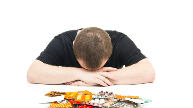 Man and medicines on a white background