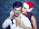 santa women seduce young men in tux at Christmas