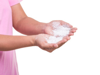 Woman holding white powder isolated on white background